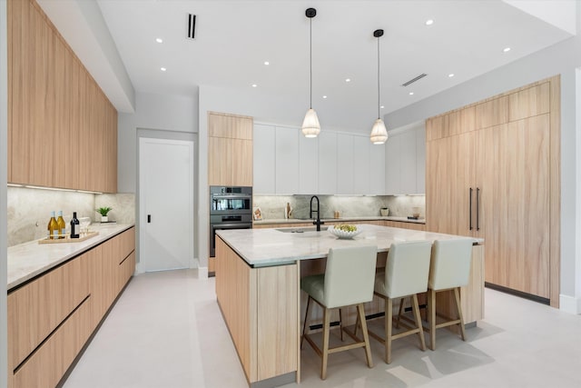 2265 NE 30th Ct, Lighthouse Point, FL 33064 - kitchen with modern cabinets, a spacious island, a kitchen breakfast bar, tasteful backsplash, and recessed lighting