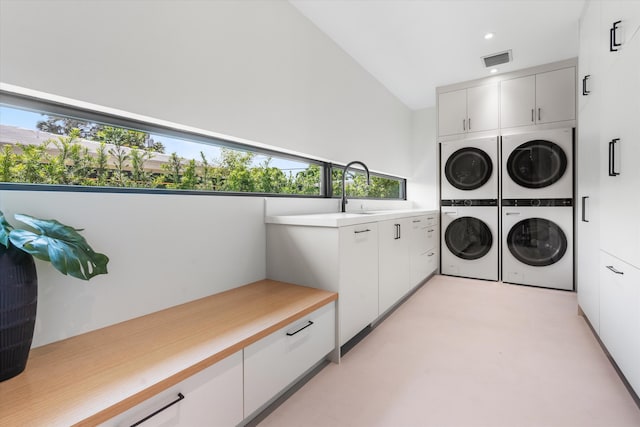 2265 NE 30th Ct, Lighthouse Point, FL 33064 - laundry area with cabinet space, stacked washer and clothes dryer, and recessed lighting
