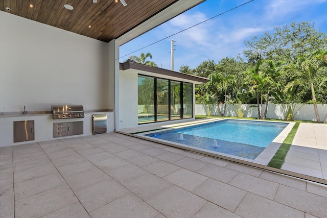2265 NE 30th Ct, Lighthouse Point, FL 33064 - view of swimming pool with exterior kitchen and a patio