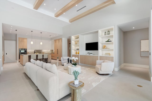 2265 NE 30th Ct, Lighthouse Point, FL 33064 - living room with built in shelves, beam ceiling, recessed lighting, and a towering ceiling