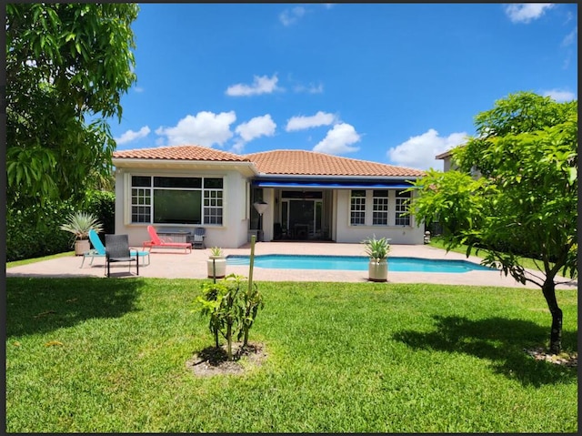 8045 NW 109th Ln, Parkland, FL 33076 - back of property with a tile roof, a patio area, an outdoor pool, and stucco siding
