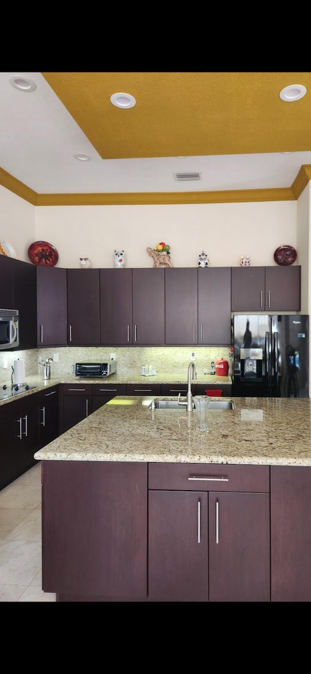 8045 NW 109th Ln, Parkland, FL 33076 - kitchen featuring black appliances, decorative backsplash, light stone countertops, light tile patterned floors, and recessed lighting