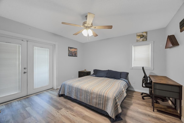 356 SW Grimaldo Ter, Port Saint Lucie, FL 34984 - bedroom featuring french doors, wood finished floors, access to exterior, and a ceiling fan
