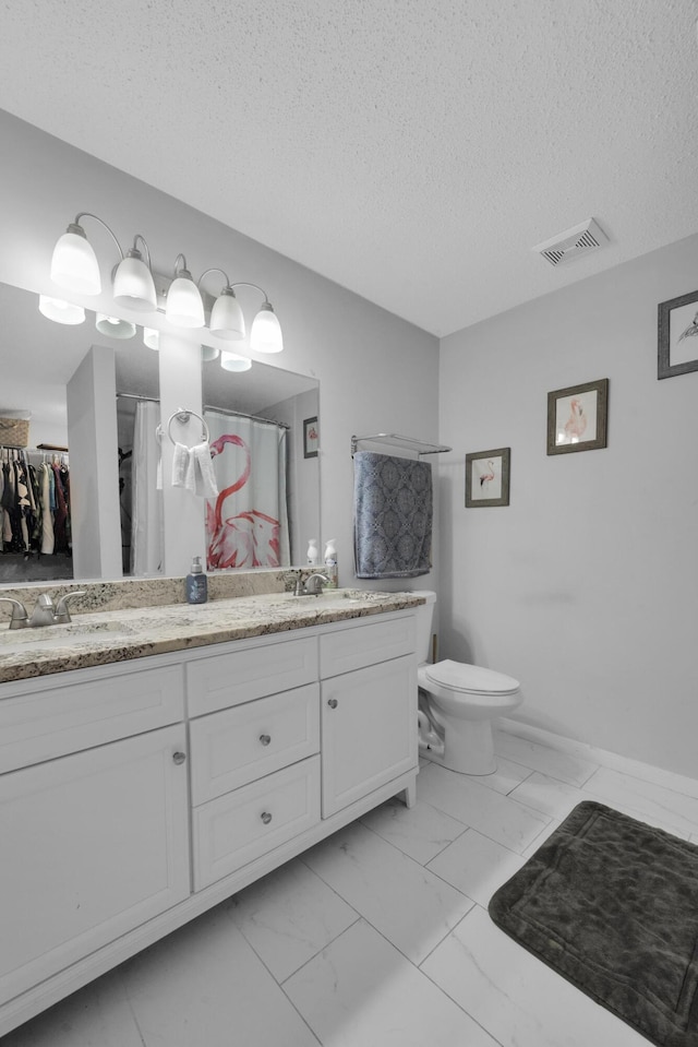 356 SW Grimaldo Ter, Port Saint Lucie, FL 34984 - full bathroom featuring marble look tile flooring, double vanity, a textured ceiling, and a shower with shower curtain