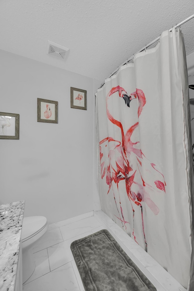 356 SW Grimaldo Ter, Port Saint Lucie, FL 34984 - bathroom with marble finish floors, vanity, a textured ceiling, and curtained shower