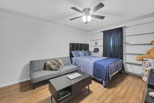 356 SW Grimaldo Ter, Port Saint Lucie, FL 34984 - bedroom featuring light wood-type flooring, a textured ceiling, and a ceiling fan