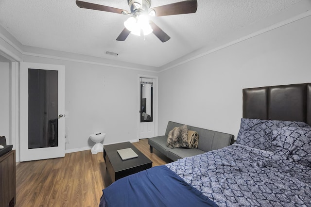 356 SW Grimaldo Ter, Port Saint Lucie, FL 34984 - bedroom with wood finished floors, a textured ceiling, and ceiling fan