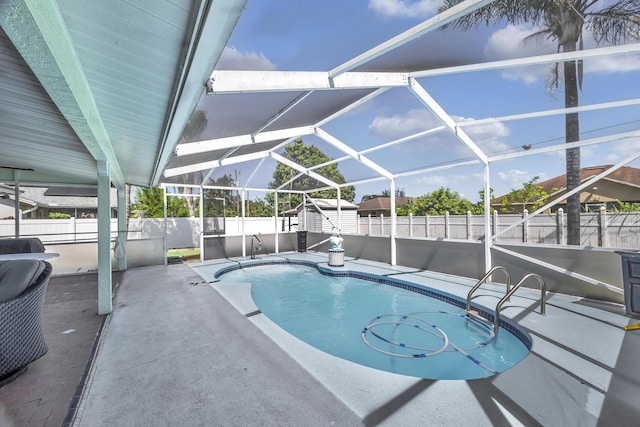 356 SW Grimaldo Ter, Port Saint Lucie, FL 34984 - view of swimming pool with a fenced backyard, a patio area, a storage shed, and glass enclosure