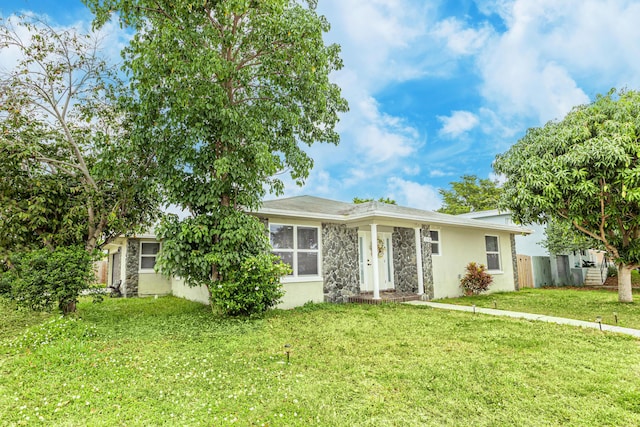 1518 Lee Ct, Lake Worth, FL 33461 - view of front of house with stucco siding, stone siding, and a front lawn