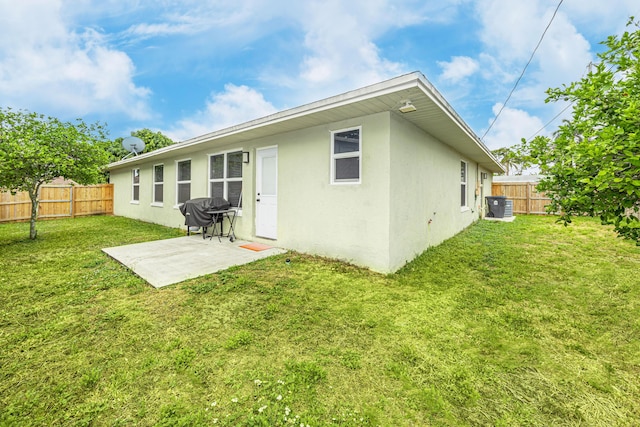 1518 Lee Ct, Lake Worth, FL 33461 - rear view of house with a fenced backyard, stucco siding, and a patio