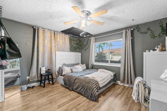 18 Winchmore Ln, Boynton Beach, FL 33426 - bedroom with wood finished floors, a textured ceiling, and a ceiling fan
