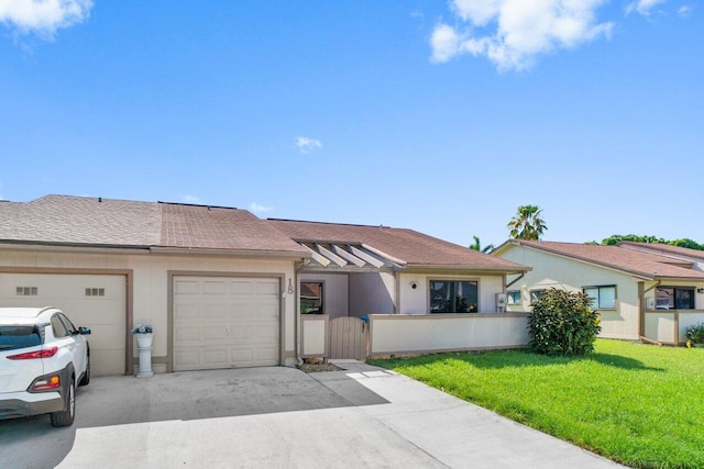 18 Winchmore Ln, Boynton Beach, FL 33426 - view of front facade with driveway, a garage, and roof with shingles