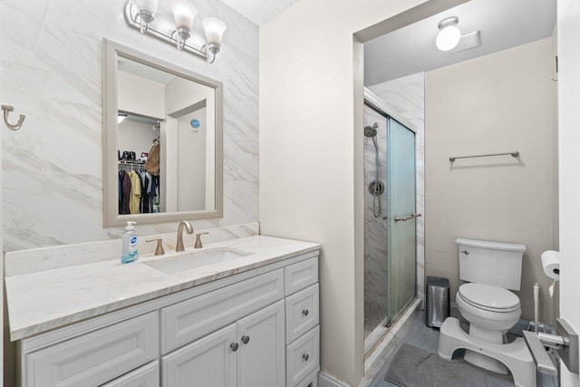18 Winchmore Ln, Boynton Beach, FL 33426 - full bath featuring vanity, a stall shower, a walk in closet, and tile walls