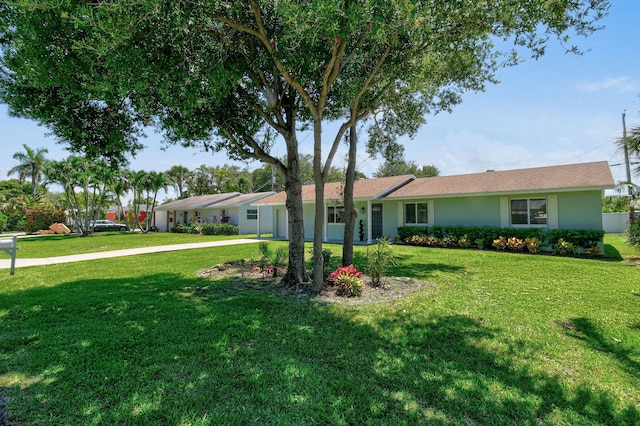 1522 Lance Rd, Jupiter, FL 33469 - ranch-style house featuring a front lawn, driveway, a garage, and stucco siding