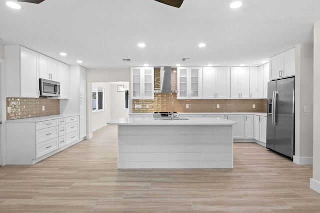 1522 Lance Rd, Jupiter, FL 33469 - kitchen featuring appliances with stainless steel finishes, wall chimney exhaust hood, light countertops, tasteful backsplash, and recessed lighting