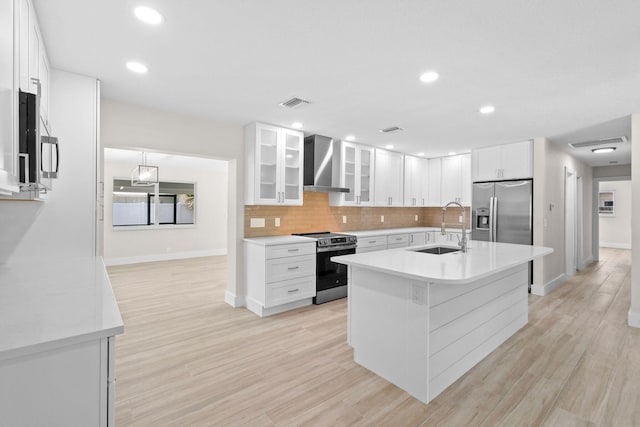 1522 Lance Rd, Jupiter, FL 33469 - kitchen with appliances with stainless steel finishes, wall chimney range hood, light countertops, white cabinetry, and recessed lighting