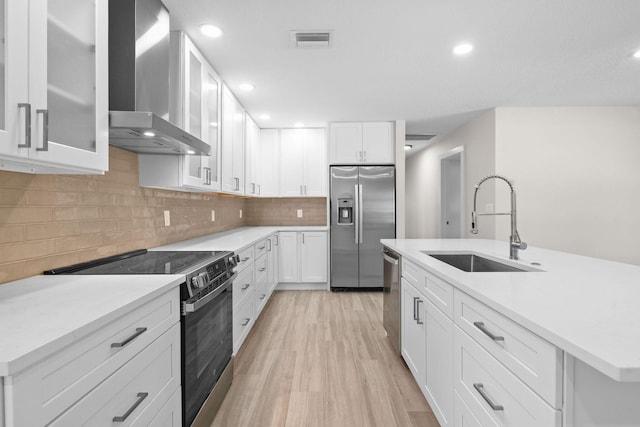 1522 Lance Rd, Jupiter, FL 33469 - kitchen with wall chimney range hood, stainless steel appliances, light countertops, white cabinets, and recessed lighting