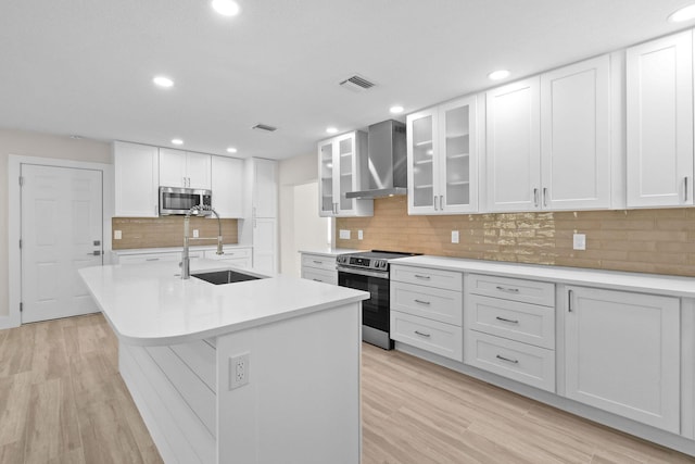 1522 Lance Rd, Jupiter, FL 33469 - kitchen with stainless steel appliances, wall chimney exhaust hood, light countertops, white cabinets, and recessed lighting