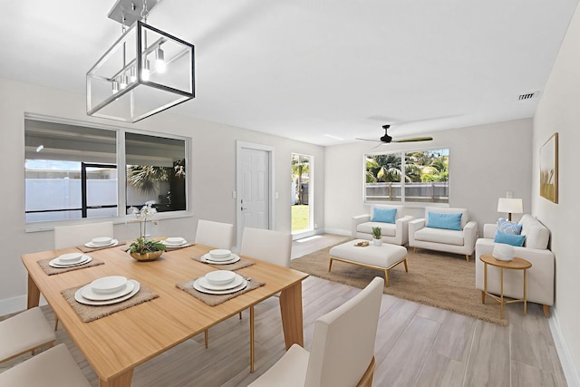 1522 Lance Rd, Jupiter, FL 33469 - dining room featuring healthy amount of natural light, ceiling fan, and light wood-type flooring