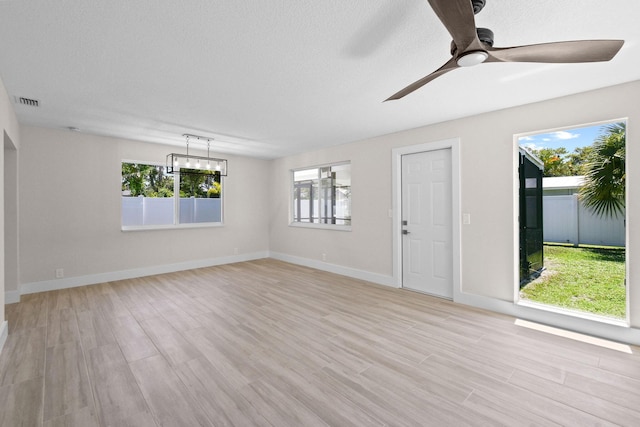 1522 Lance Rd, Jupiter, FL 33469 - unfurnished living room with ceiling fan, a chandelier, and light wood finished floors