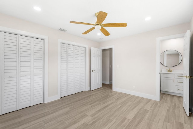 1522 Lance Rd, Jupiter, FL 33469 - unfurnished bedroom with multiple closets, light wood-style floors, recessed lighting, ensuite bathroom, and a ceiling fan