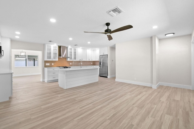 1522 Lance Rd, Jupiter, FL 33469 - kitchen with stainless steel appliances, wall chimney range hood, tasteful backsplash, white cabinets, and a ceiling fan