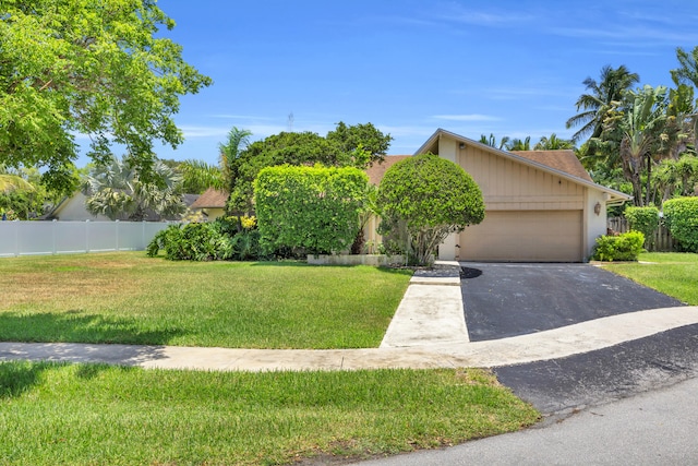 9070 NW 16th St, Plantation, FL 33322 - obstructed view of property featuring asphalt driveway and an attached garage