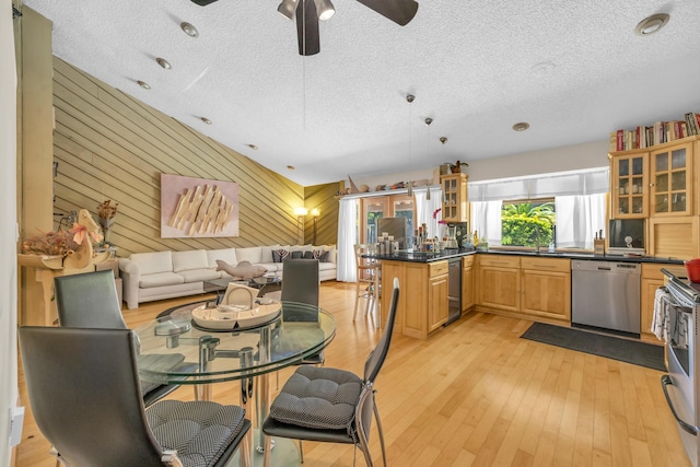 9070 NW 16th St, Plantation, FL 33322 - dining space with a textured ceiling, ceiling fan, light wood-type flooring, and wood walls