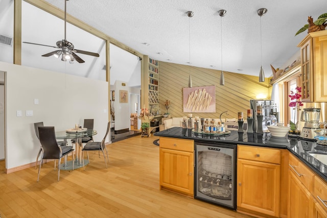 9070 NW 16th St, Plantation, FL 33322 - kitchen featuring wine cooler, dark countertops, a ceiling fan, lofted ceiling, and light wood-style flooring