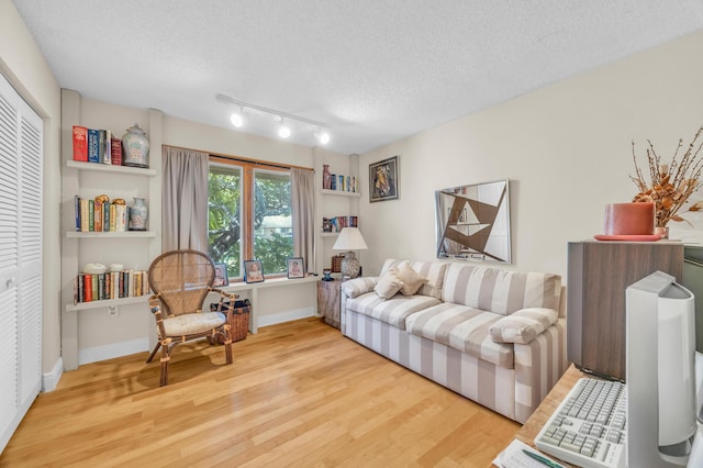 9070 NW 16th St, Plantation, FL 33322 - living area featuring wood finished floors and a textured ceiling