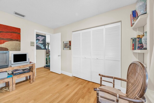 9070 NW 16th St, Plantation, FL 33322 - living area with light wood finished floors and a textured ceiling