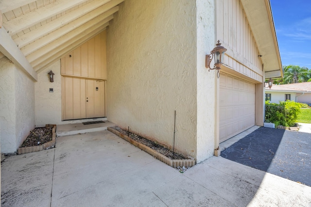 9070 NW 16th St, Plantation, FL 33322 - property entrance featuring stucco siding, driveway, and an attached garage