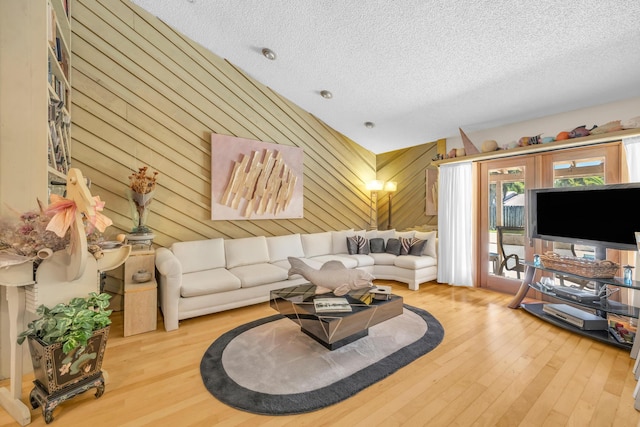 9070 NW 16th St, Plantation, FL 33322 - living room featuring wood finished floors, a textured ceiling, and wooden walls