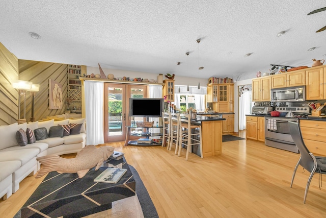9070 NW 16th St, Plantation, FL 33322 - living room with light wood-type flooring and a textured ceiling