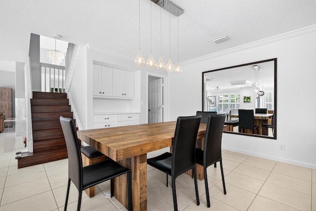5086 Prairie Dunes Village Cir, Lake Worth, FL 33463 - dining room with a chandelier, a textured ceiling, stairs, light tile patterned floors, and ornamental molding