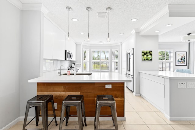 5086 Prairie Dunes Village Cir, Lake Worth, FL 33463 - kitchen with a peninsula, modern cabinets, stainless steel appliances, light countertops, and a textured ceiling