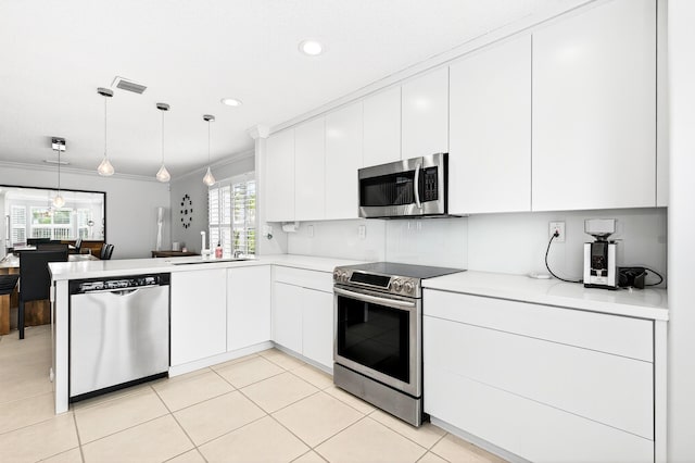 5086 Prairie Dunes Village Cir, Lake Worth, FL 33463 - kitchen with appliances with stainless steel finishes, a peninsula, light countertops, white cabinetry, and pendant lighting