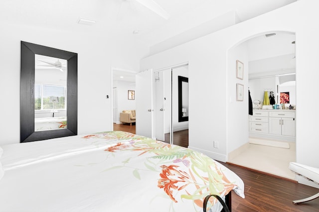 5086 Prairie Dunes Village Cir, Lake Worth, FL 33463 - bedroom featuring wood finished floors, arched walkways, and connected bathroom