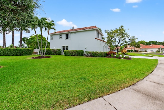 5086 Prairie Dunes Village Cir, Lake Worth, FL 33463 - view of side of property with a lawn, stucco siding, and concrete driveway