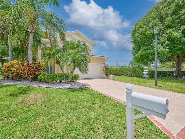 10889 Fillmore Dr, Boynton Beach, FL 33437 - view of front of property featuring concrete driveway, stucco siding, a front yard, an attached garage, and a tiled roof
