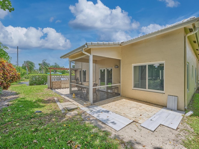 10889 Fillmore Dr, Boynton Beach, FL 33437 - back of house featuring a patio, stucco siding, and a yard