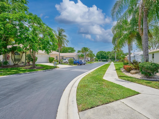 10889 Fillmore Dr, Boynton Beach, FL 33437 - view of asphalt road with sidewalks, a residential view, and curbs