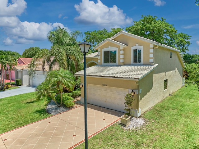 10889 Fillmore Dr, Boynton Beach, FL 33437 - view of front of house with stucco siding, a garage, driveway, a tile roof, and a front lawn