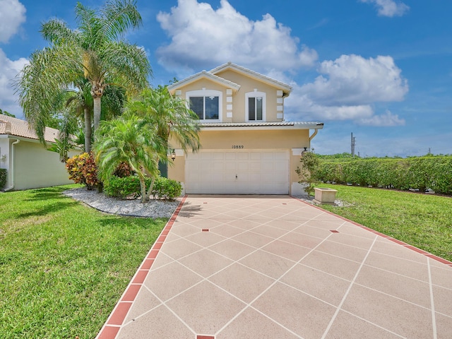 10889 Fillmore Dr, Boynton Beach, FL 33437 - mediterranean / spanish house with a garage, concrete driveway, stucco siding, a front yard, and a tile roof