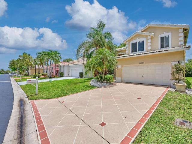 10889 Fillmore Dr, Boynton Beach, FL 33437 - mediterranean / spanish-style house featuring driveway, a garage, stucco siding, and a front yard