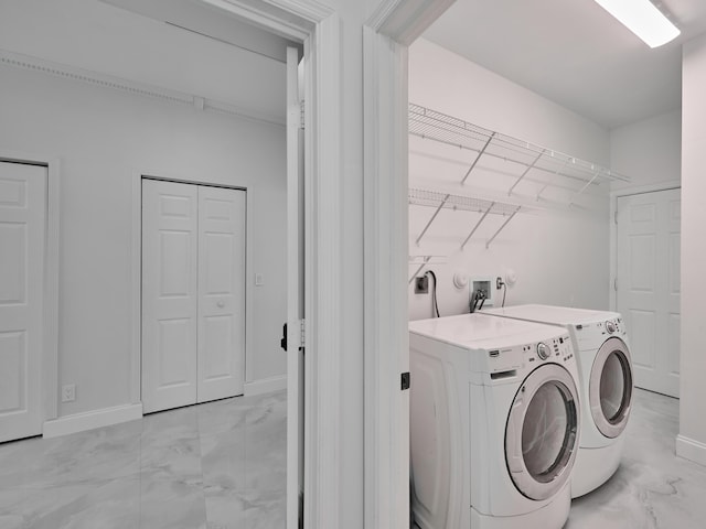 10889 Fillmore Dr, Boynton Beach, FL 33437 - laundry area featuring independent washer and dryer and light marble finish flooring