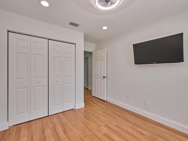 10889 Fillmore Dr, Boynton Beach, FL 33437 - unfurnished bedroom featuring light wood-type flooring, recessed lighting, and a closet