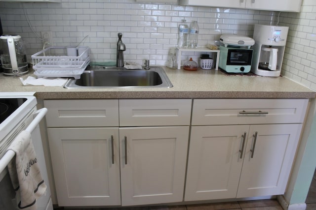 333 Northampton Unit Q, West Palm Beach, FL 33417 - kitchen with backsplash, white electric stove, and white cabinets