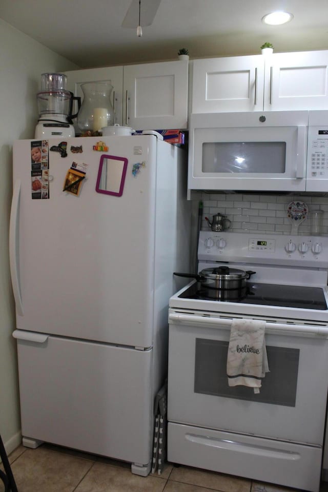 333 Northampton Unit Q, West Palm Beach, FL 33417 - kitchen featuring white appliances, decorative backsplash, white cabinetry, light tile patterned floors, and recessed lighting