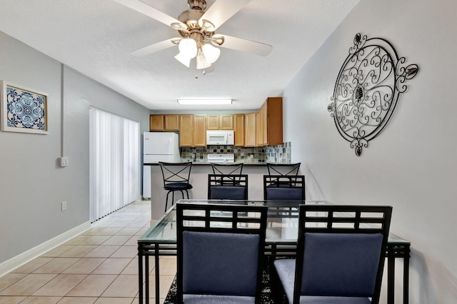 3675 SW Sunset Trace Cir, Palm City, FL 34990 - dining room with a ceiling fan, light tile patterned flooring, and a textured ceiling